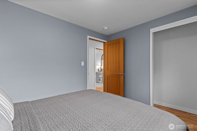 430 S 201st St, Des Moines, WA 98198 - unfurnished bedroom with wood finished floors, a closet, and baseboards