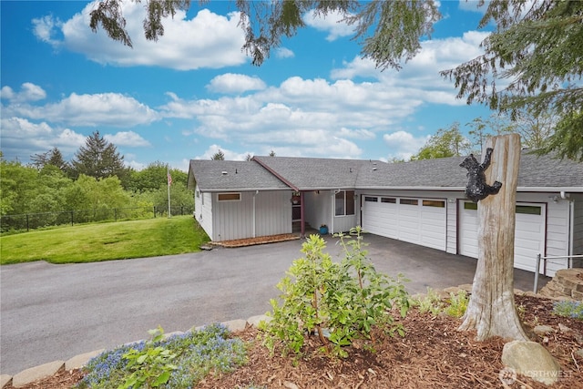 ranch-style home with driveway and an attached garage