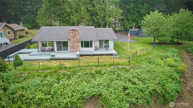 rear view of house featuring a deck and a chimney