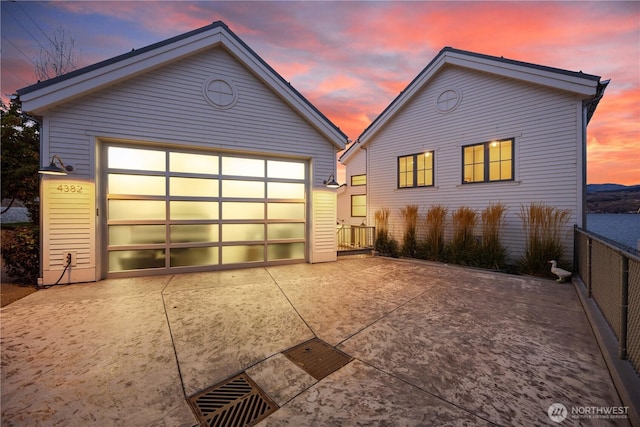 view of front of house with an outbuilding and concrete driveway