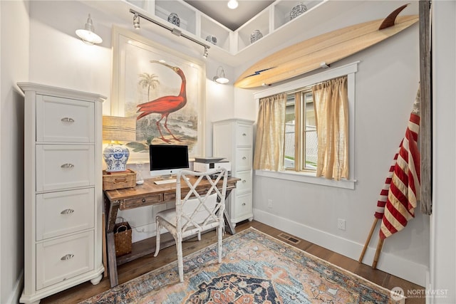 office area with baseboards and wood finished floors