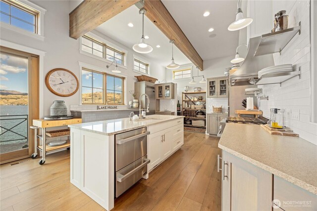 kitchen featuring beam ceiling, a sink, dishwasher, decorative backsplash, and recessed lighting