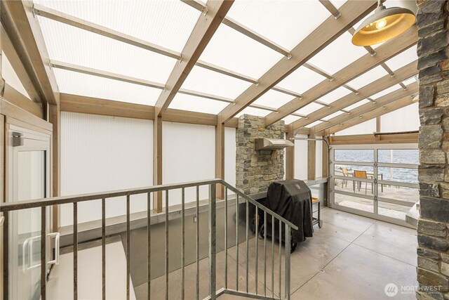 sunroom featuring vaulted ceiling