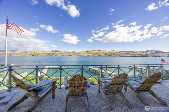 view of patio with a water and mountain view