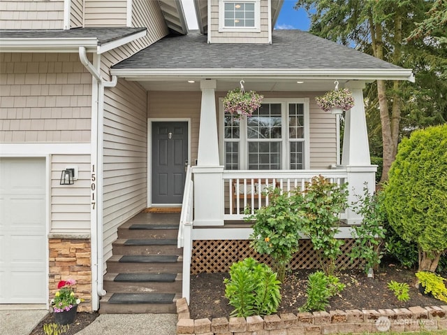 15017 46th Ave SE, Everett, WA 98208 - view of exterior entry featuring a porch, a garage, and roof with shingles