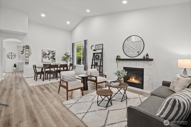 15017 46th Ave SE, Everett, WA 98208 - living room with a tile fireplace, recessed lighting, light wood-type flooring, high vaulted ceiling, and baseboards