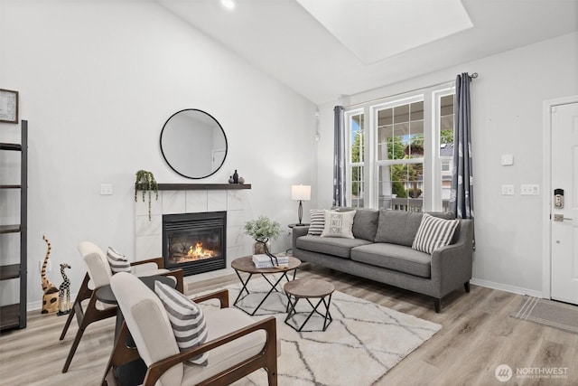 15017 46th Ave SE, Everett, WA 98208 - living area featuring light wood-style floors, a tile fireplace, lofted ceiling, and baseboards