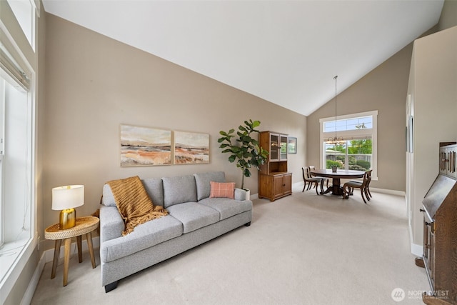 1855 Shanon Ln, Enumclaw, WA 98022 - living room with light colored carpet, high vaulted ceiling, baseboards, and a chandelier