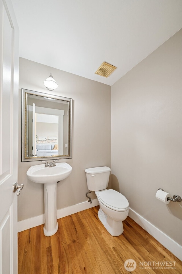 1855 Shanon Ln, Enumclaw, WA 98022 - half bath with toilet, baseboards, wood finished floors, and a sink