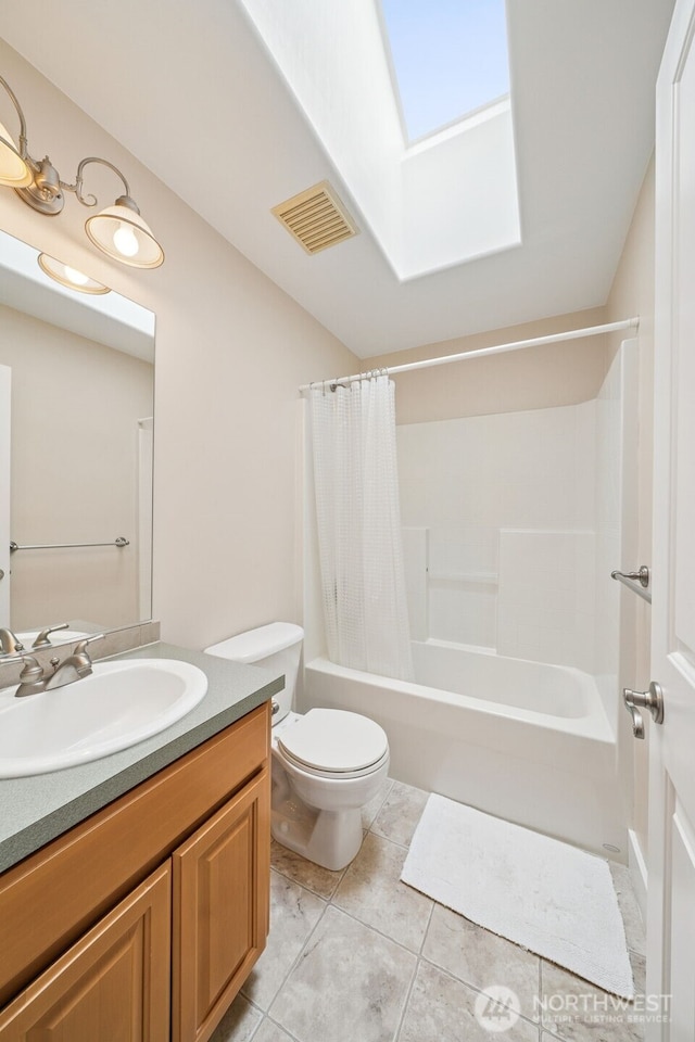 1855 Shanon Ln, Enumclaw, WA 98022 - bathroom with a skylight, toilet, vanity, shower / bathtub combination with curtain, and tile patterned flooring