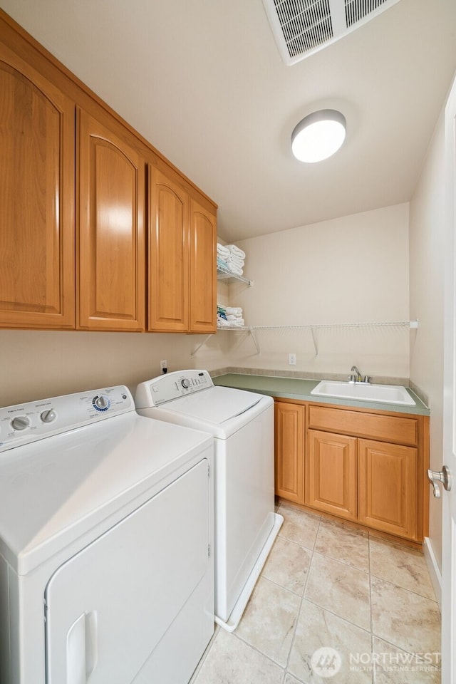 1855 Shanon Ln, Enumclaw, WA 98022 - laundry room featuring cabinet space, washer and clothes dryer, and light tile patterned floors