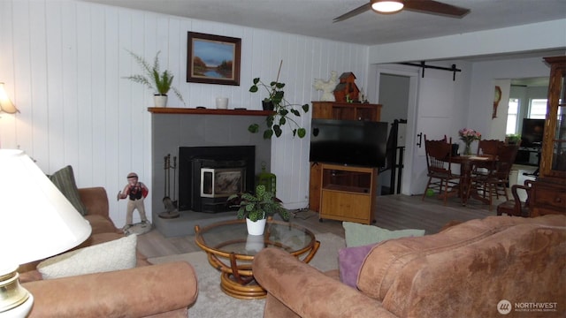145 Collar Ave, Morton, WA 98356 - living area with a barn door, ceiling fan, and wood finished floors