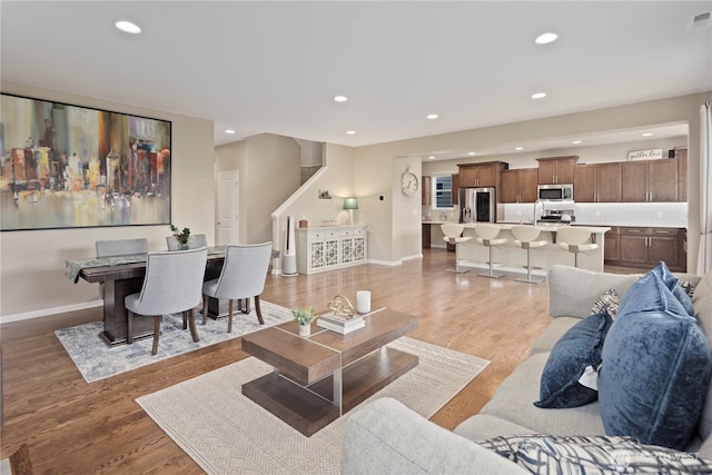 4422 Riverfront Blvd, Everett, WA 98203 - living room featuring recessed lighting, stairs, baseboards, and light wood-style floors