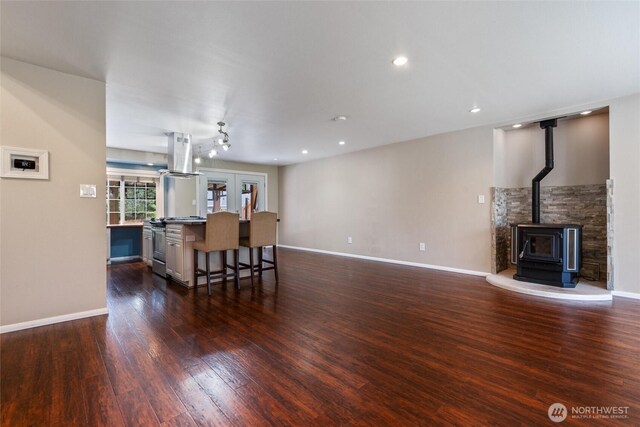 3620 Westminster Dr SE, Port Orchard, WA 98366 - living room with dark wood finished floors, a wood stove, baseboards, and recessed lighting