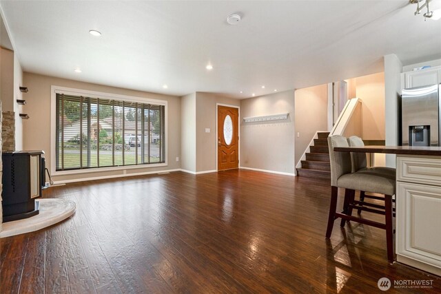 3620 Westminster Dr SE, Port Orchard, WA 98366 - living area with wood finished floors, baseboards, a wood stove, recessed lighting, and stairs
