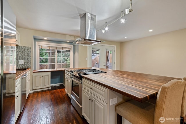 3620 Westminster Dr SE, Port Orchard, WA 98366 - kitchen featuring appliances with stainless steel finishes, wood counters, island range hood, french doors, and dark wood-style flooring