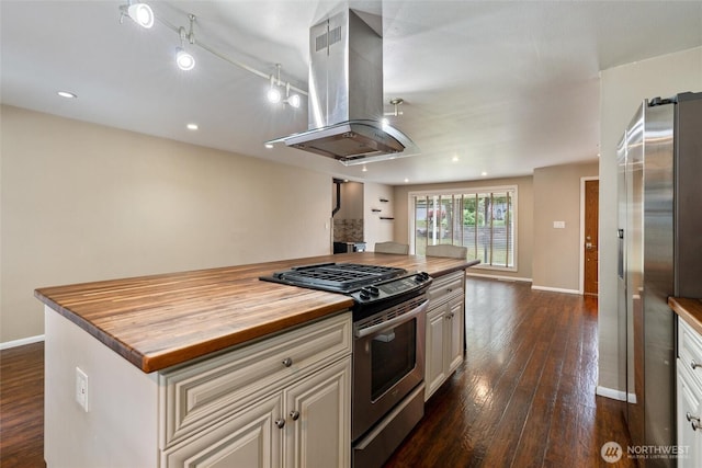 3620 Westminster Dr SE, Port Orchard, WA 98366 - kitchen with stainless steel appliances, wood counters, island range hood, dark wood-type flooring, and baseboards