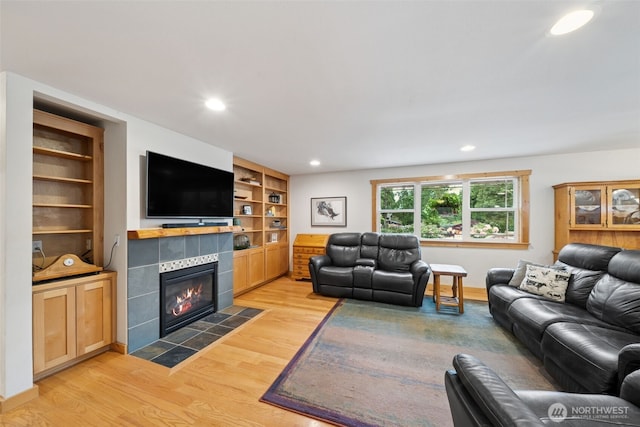 39800 224th Ave SE, Enumclaw, WA 98022 - living area with light wood finished floors, recessed lighting, a tiled fireplace, and built in shelves
