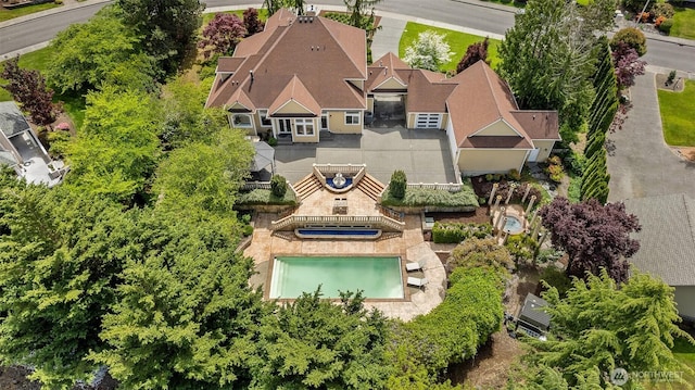 aerial view of property and surrounding area featuring a pool