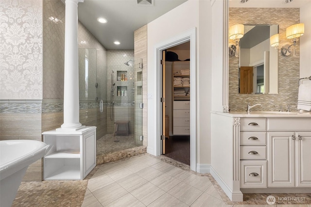 full bath featuring ornate columns, a shower stall, tile patterned floors, vanity, and recessed lighting