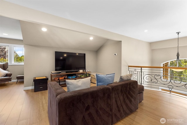 living area with light wood-style flooring, recessed lighting, and baseboards