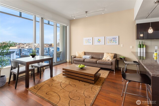 737 Olive Way Unit 2703, Seattle, WA 98101 - living room featuring rail lighting and wood finished floors