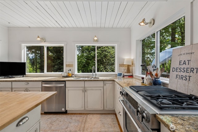 15715 249th Ave SE, Issaquah, WA 98027 - kitchen featuring stainless steel appliances, a sink, healthy amount of natural light, wood ceiling, and tasteful backsplash