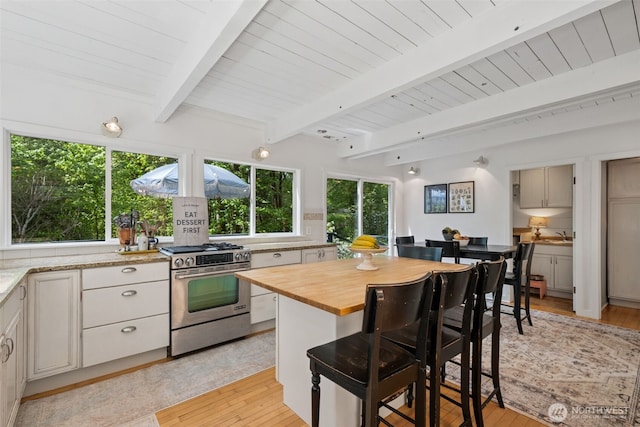 15715 249th Ave SE, Issaquah, WA 98027 - kitchen featuring stainless steel range with gas cooktop, wood counters, light wood finished floors, a breakfast bar area, and wood ceiling