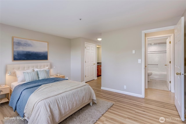 8260 53rd Ave W Unit 208, Mukilteo, WA 98275 - bedroom with light wood finished floors, baseboards, and ensuite bath