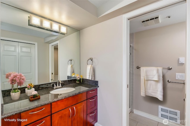 8260 53rd Ave W Unit 208, Mukilteo, WA 98275 - full bathroom featuring vanity, tile patterned flooring, baseboards, and a shower
