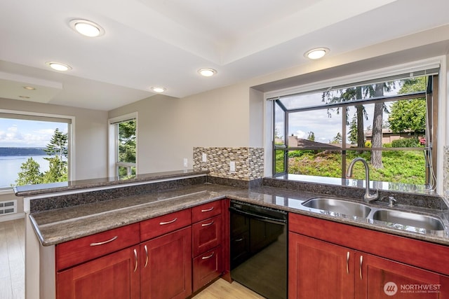 8260 53rd Ave W Unit 208, Mukilteo, WA 98275 - kitchen featuring dishwasher, a sink, dark brown cabinets, light wood finished floors, and a peninsula