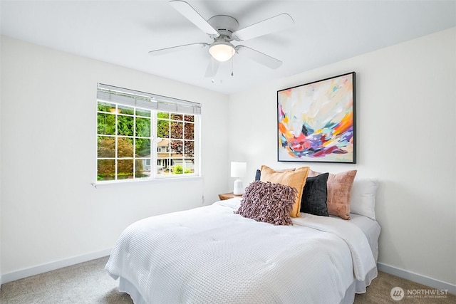carpeted bedroom featuring baseboards and a ceiling fan