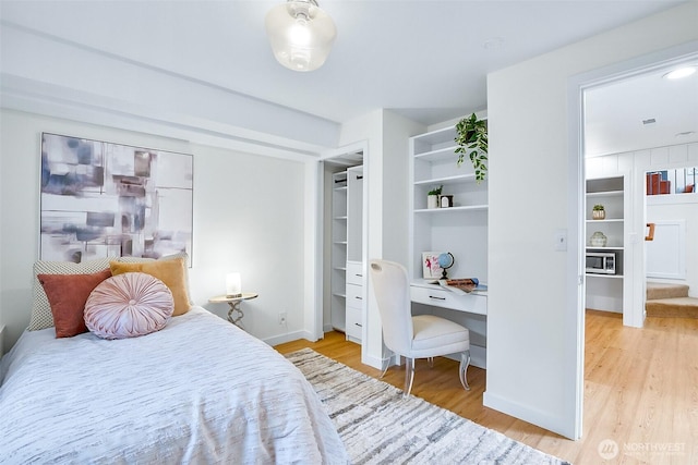 bedroom featuring wood finished floors and baseboards