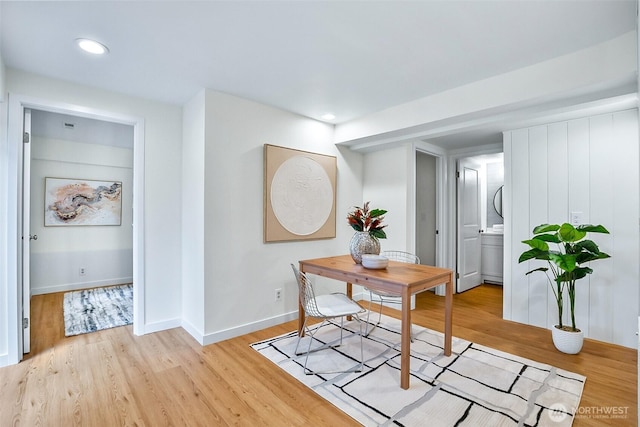 office area with light wood-style flooring, baseboards, recessed lighting, and stacked washing machine and dryer
