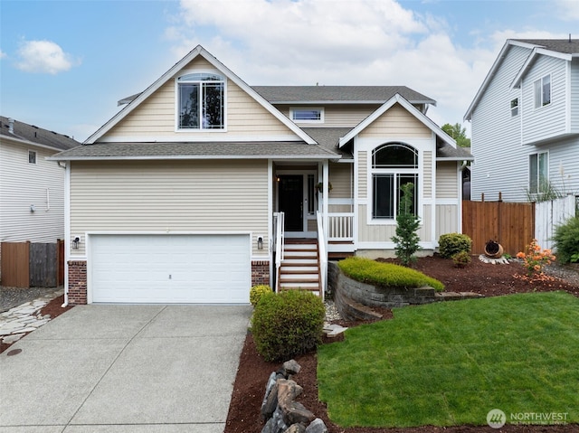 view of front of home featuring an attached garage, concrete driveway, and roof with shingles