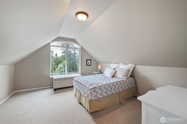 bedroom with light carpet, lofted ceiling, and baseboards