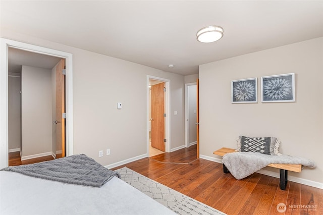 bedroom with baseboards and wood finished floors