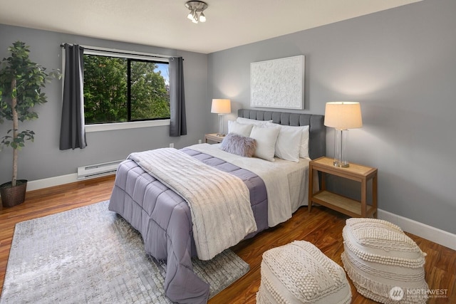610 Aloha St Unit 303, Seattle, WA 98109 - bedroom with a baseboard radiator, baseboards, and wood finished floors