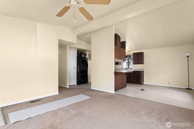 8322 19th Ave Court E Unit 11, Tacoma, WA 98404 - unfurnished living room featuring light colored carpet, baseboards, a ceiling fan, and vaulted ceiling