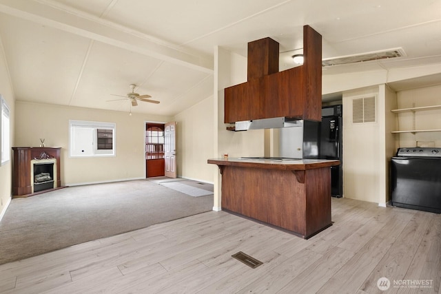 8322 19th Ave Court E Unit 11, Tacoma, WA 98404 - kitchen featuring washer / dryer, freestanding refrigerator, a peninsula, light wood-style flooring, and plenty of natural light