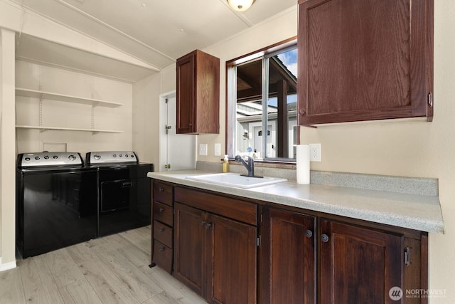 8322 19th Ave Court E Unit 11, Tacoma, WA 98404 - kitchen featuring a sink, washer and clothes dryer, light countertops, lofted ceiling, and light wood finished floors
