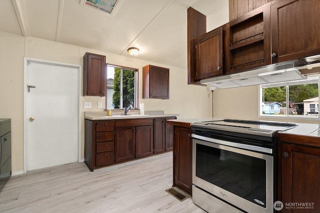 8322 19th Ave Court E Unit 11, Tacoma, WA 98404 - kitchen featuring stainless steel electric range oven, under cabinet range hood, open shelves, light countertops, and a sink