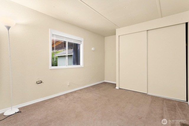 8322 19th Ave Court E Unit 11, Tacoma, WA 98404 - unfurnished bedroom with carpet, baseboards, and a closet