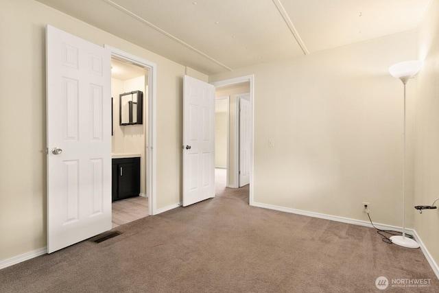 8322 19th Ave Court E Unit 11, Tacoma, WA 98404 - unfurnished bedroom featuring light carpet, baseboards, and connected bathroom