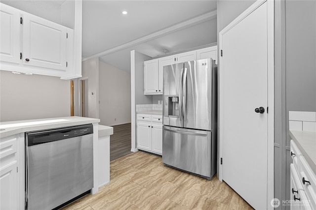 kitchen featuring stainless steel appliances, light countertops, white cabinets, and recessed lighting