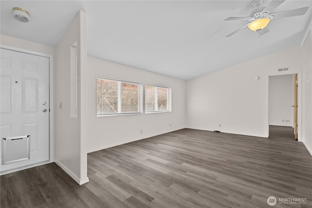foyer featuring lofted ceiling, dark wood-type flooring, ceiling fan, and baseboards