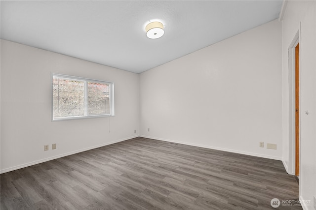 unfurnished room featuring dark wood finished floors and baseboards