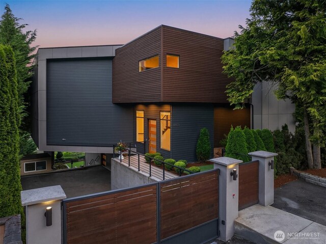8553 NE Juanita Dr, Kirkland, WA 98034 - modern home with a fenced front yard and a gate