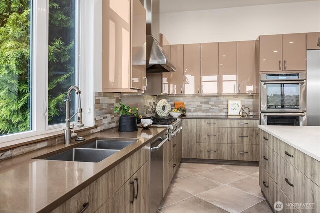 8553 NE Juanita Dr, Kirkland, WA 98034 - kitchen featuring wall chimney exhaust hood, stainless steel appliances, decorative backsplash, light tile patterned floors, and modern cabinets