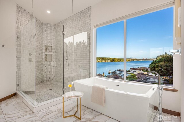 8553 NE Juanita Dr, Kirkland, WA 98034 - bathroom with marble finish floors, a freestanding tub, a water view, a stall shower, and recessed lighting